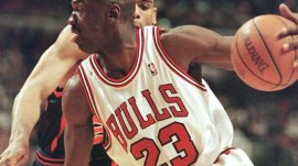 Michael Jordan drives to the basket past the New York Knicks' Allan Houston during the first half in Chicago, April 18, 1998..